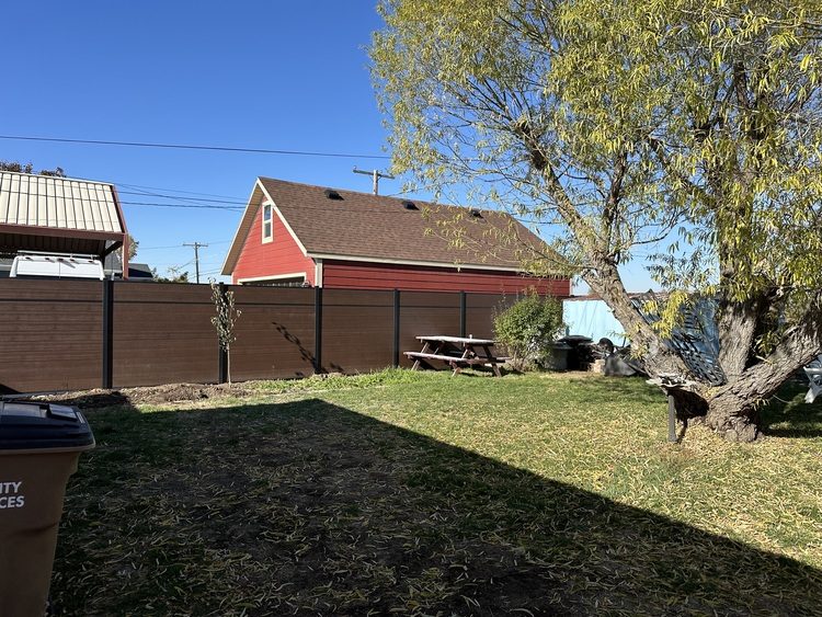 Integral composite privacy fence enclosing a Northern Utah backyard