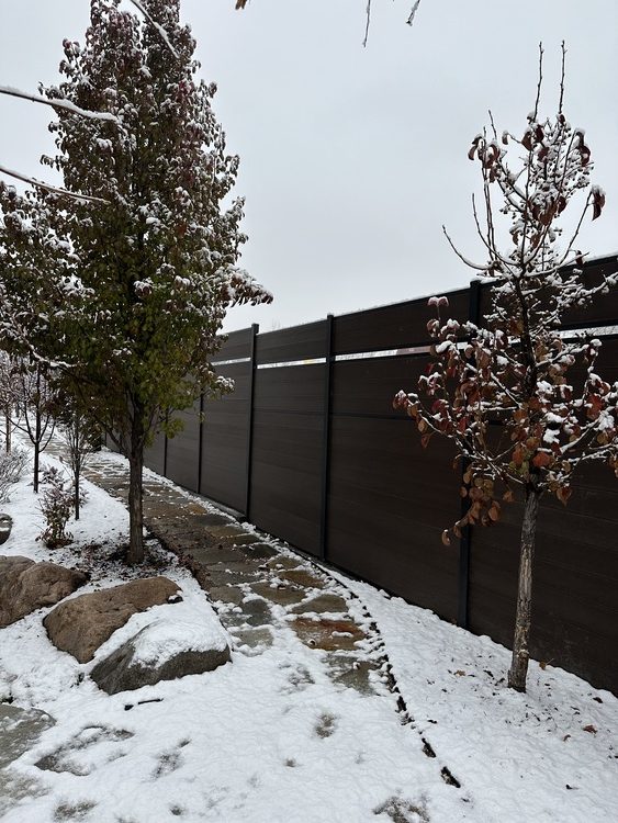 Integral composite fence standing up to a Utah winter